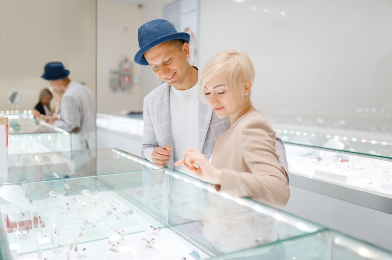 A couple looking at jewels in jewelry store.